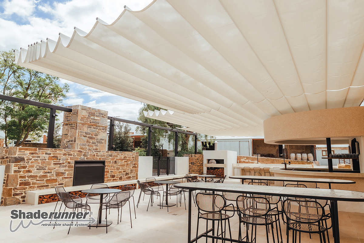 A large Shaderunner retractable canopy over an outdoor entertaining area